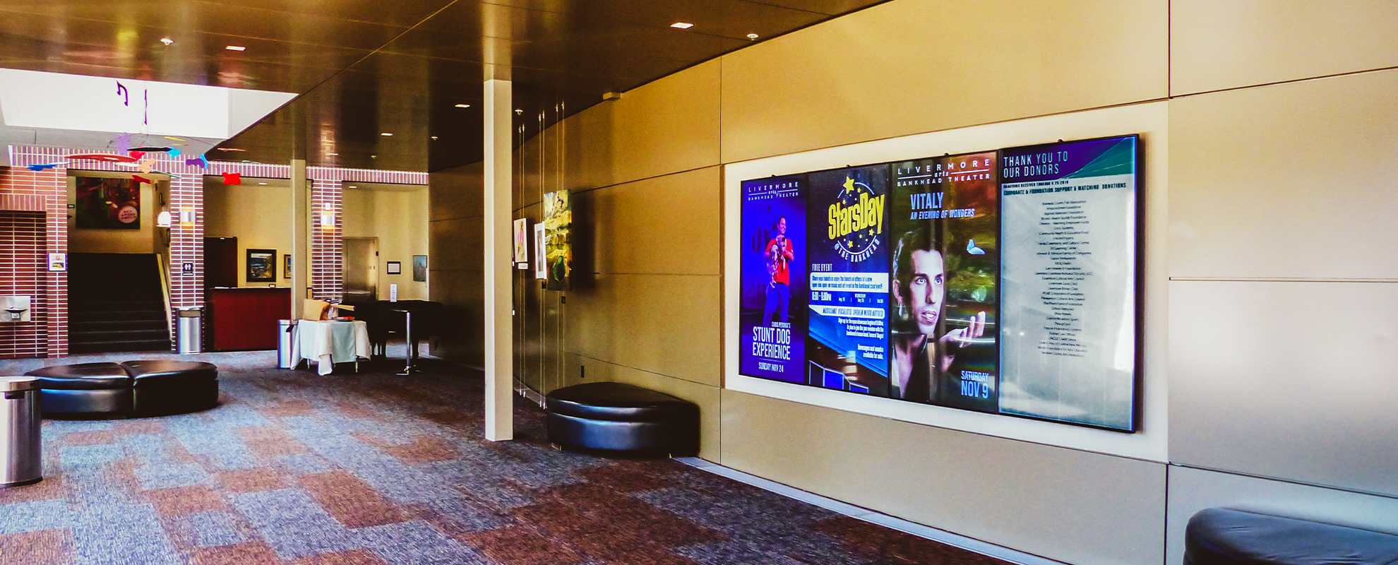 Four digital signs displaying event information at Livermore Performing Arts Center.