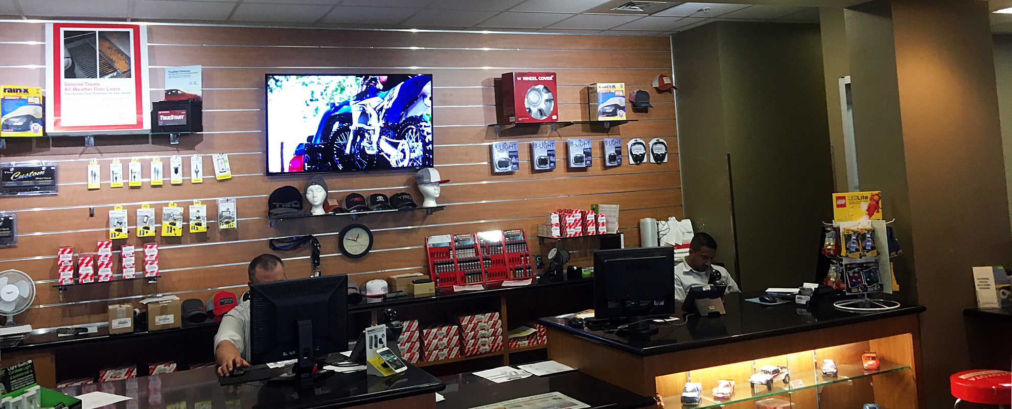 A customer looking at a service menu on a digital sign at Modesto Toyota.